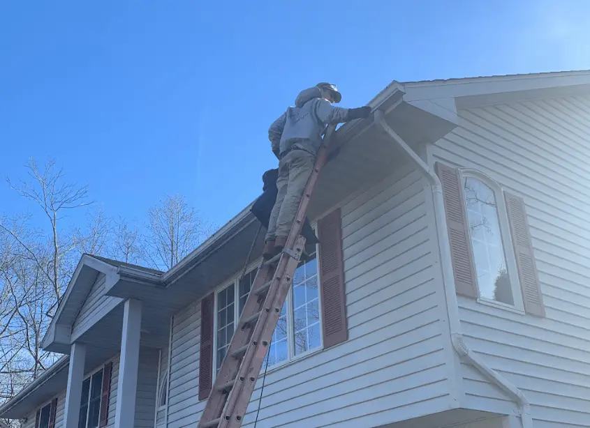 Gutter cleaning and maintenance being performed by Willoughby Power Washing in Willoughby